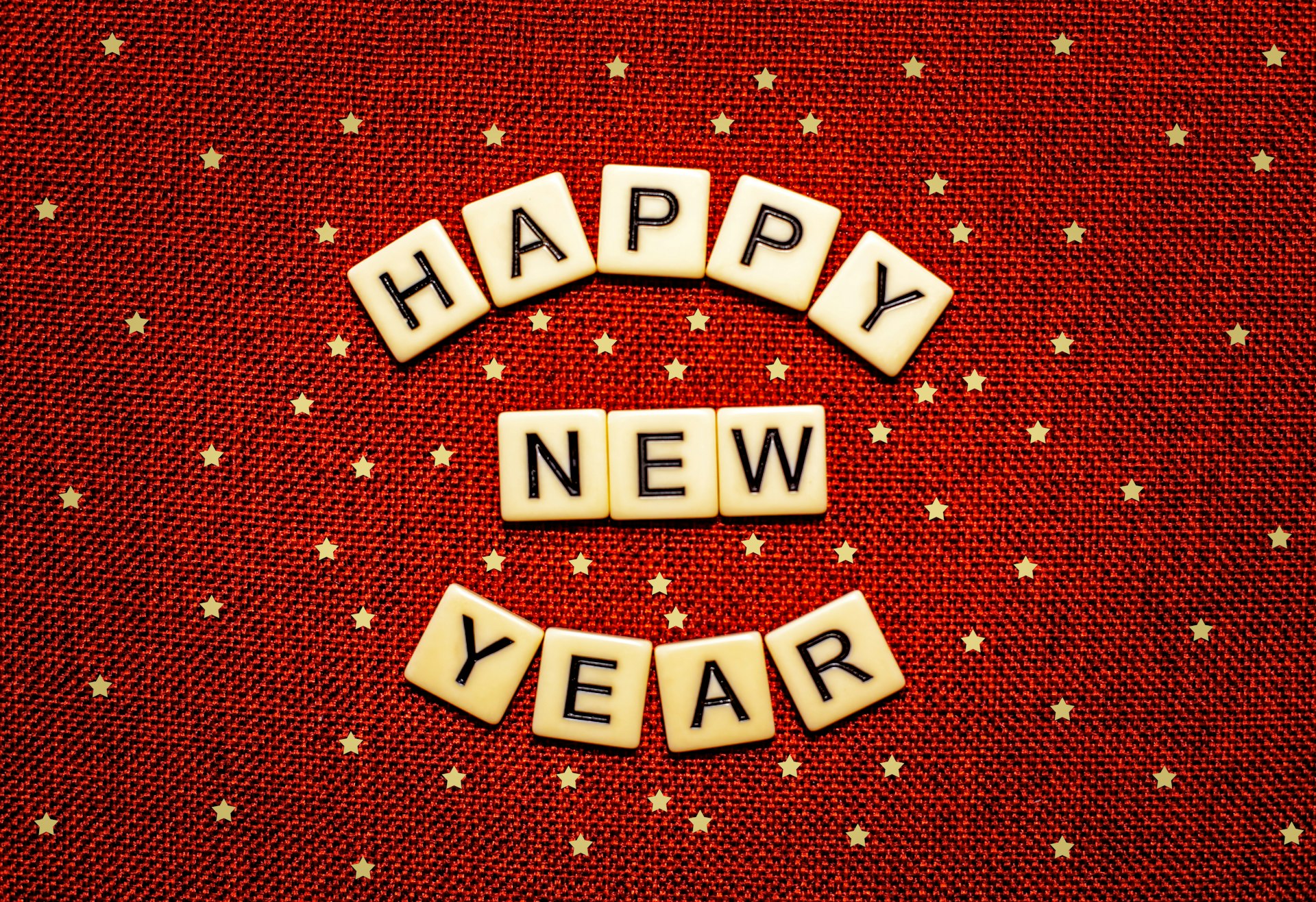 happy new year spelled with scrabbles on a red background